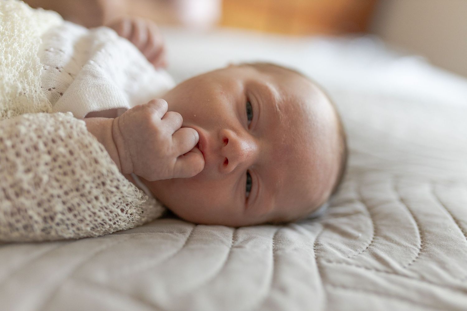 Newborn baby girl sleeping on the bed with floral swaddles at home newborn session, Caroline Springs Melb, Vic