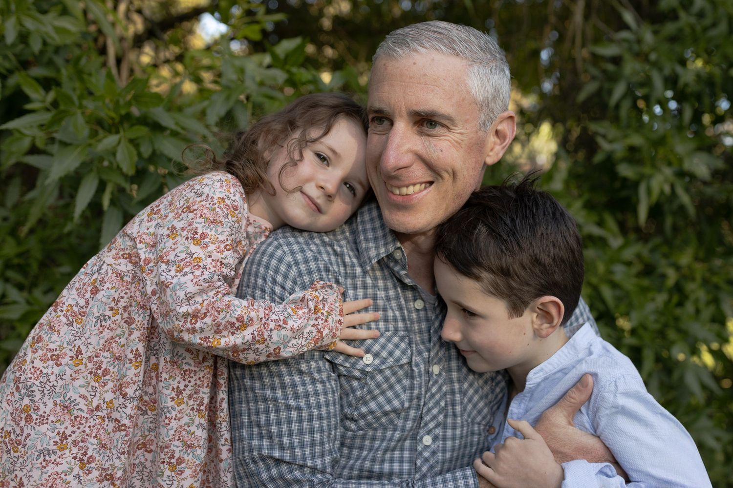 Son and daughter hugging their dad Outdoor at home family Woodend, Melbourne, Victoria