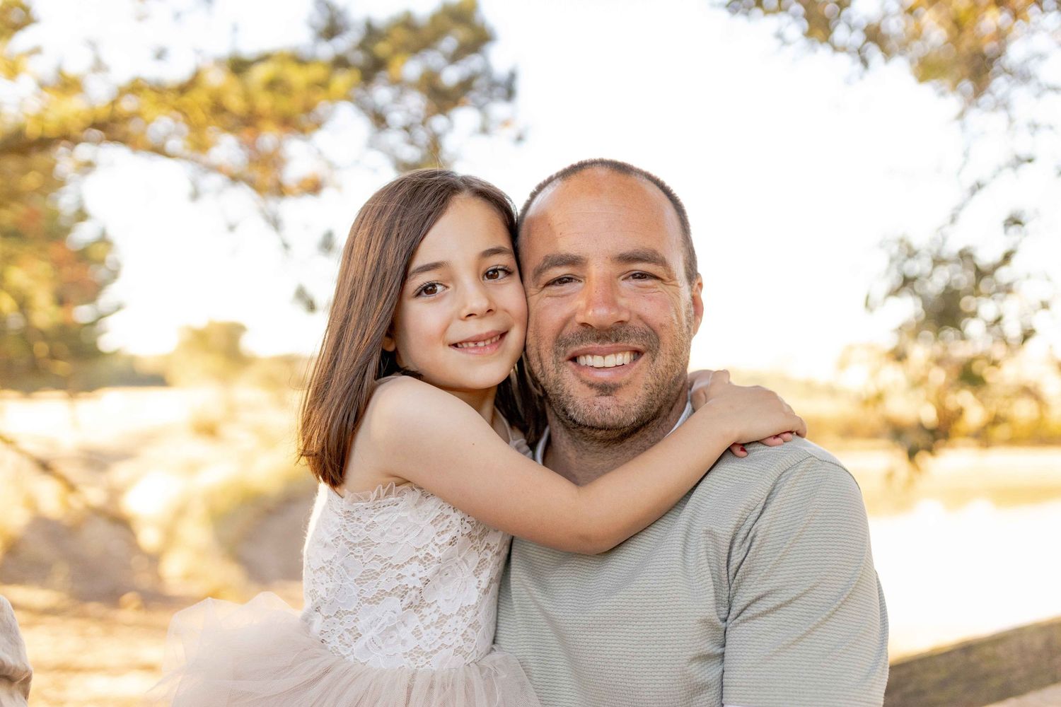 Father and daughter hugging and smiling Outdoor at home family session Gisborne Melb Vic