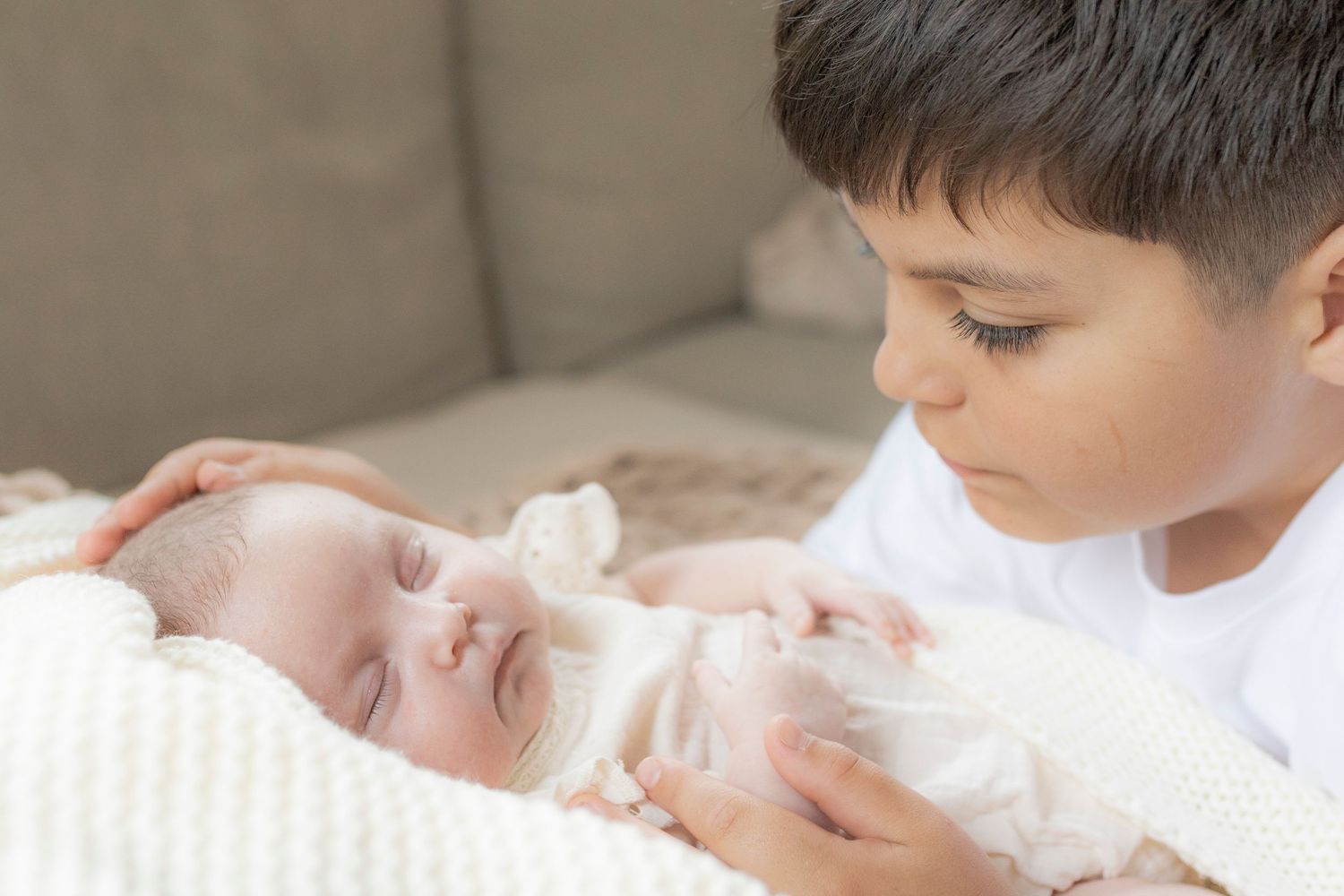Big brother looking at his newborn sister newborn photoshoot Melbourne west