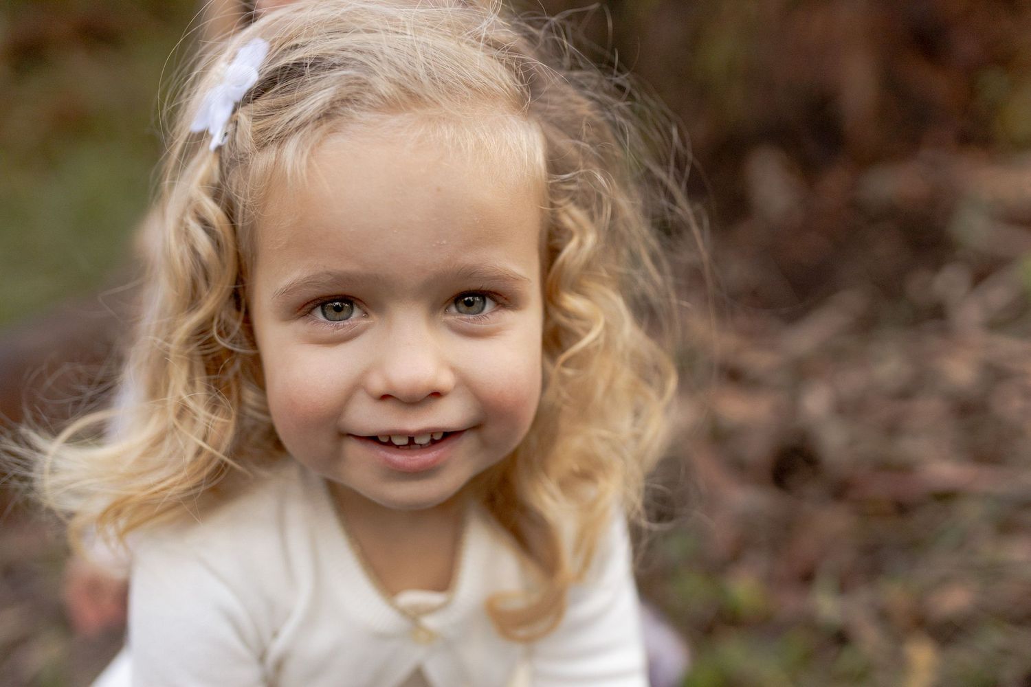 Close up of little girl smiling golden ringlets Outdoor family session Macedon Ranges Melb Vic