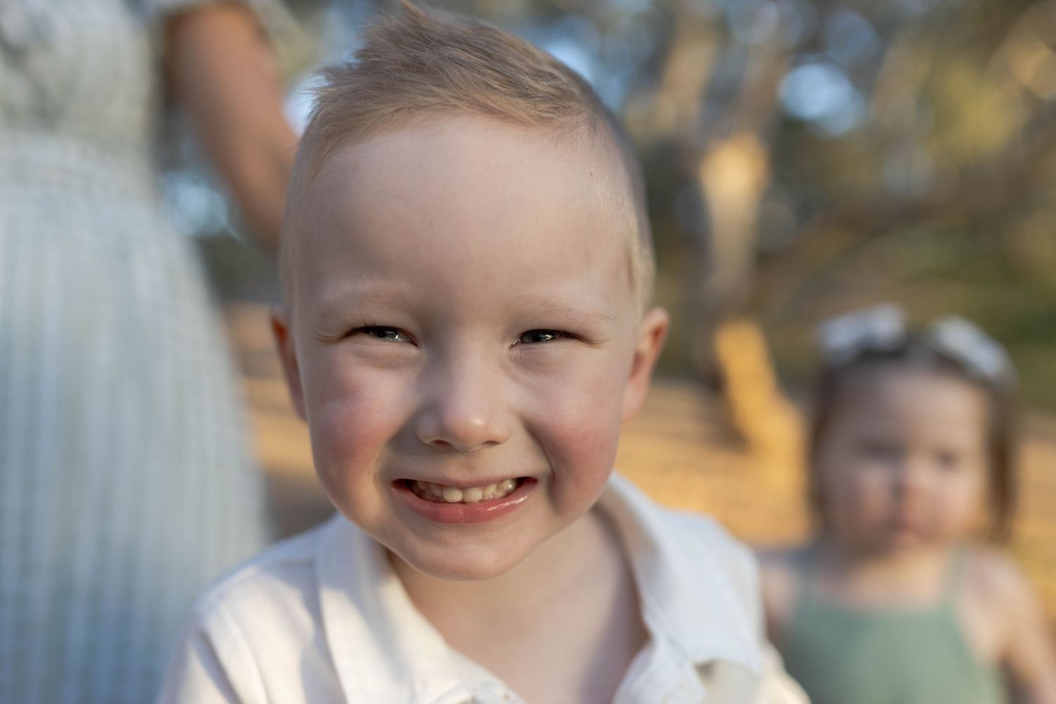Little boy smiling into the camera, rosy cheeks outdoor family session Newport Lakes, Melbourne Victoria