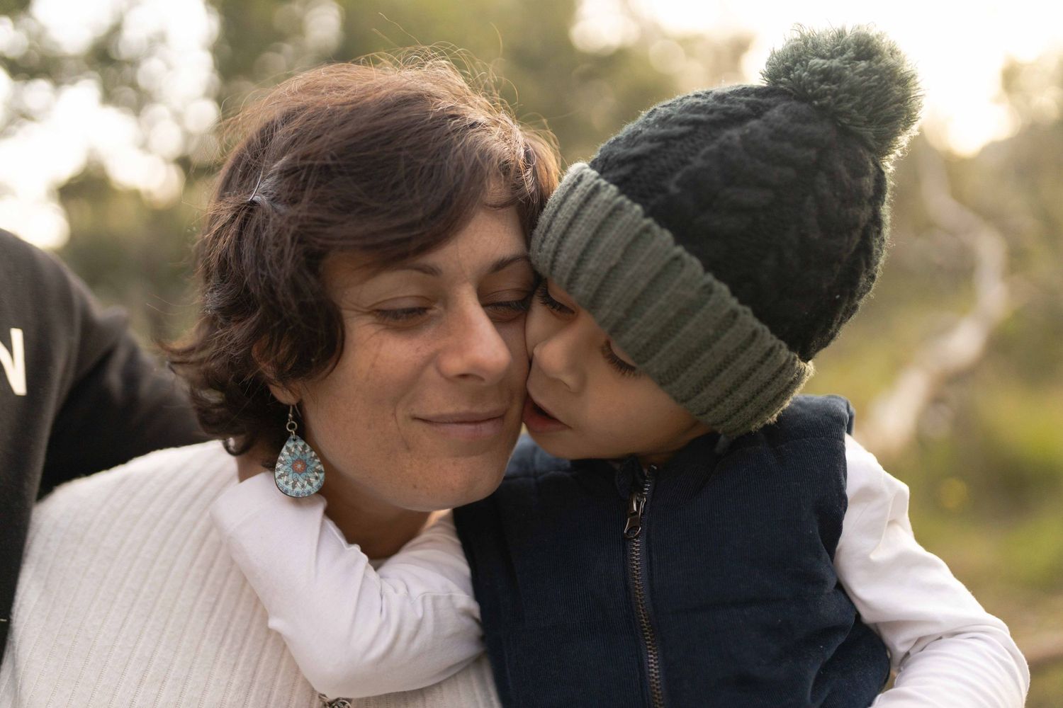 mum and son have their faces together with their eyes closed Outdoor maternity session Sunshine Melb Victoria