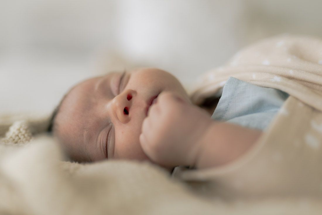 close up of Newborn baby boy wrapped in a soft blanket