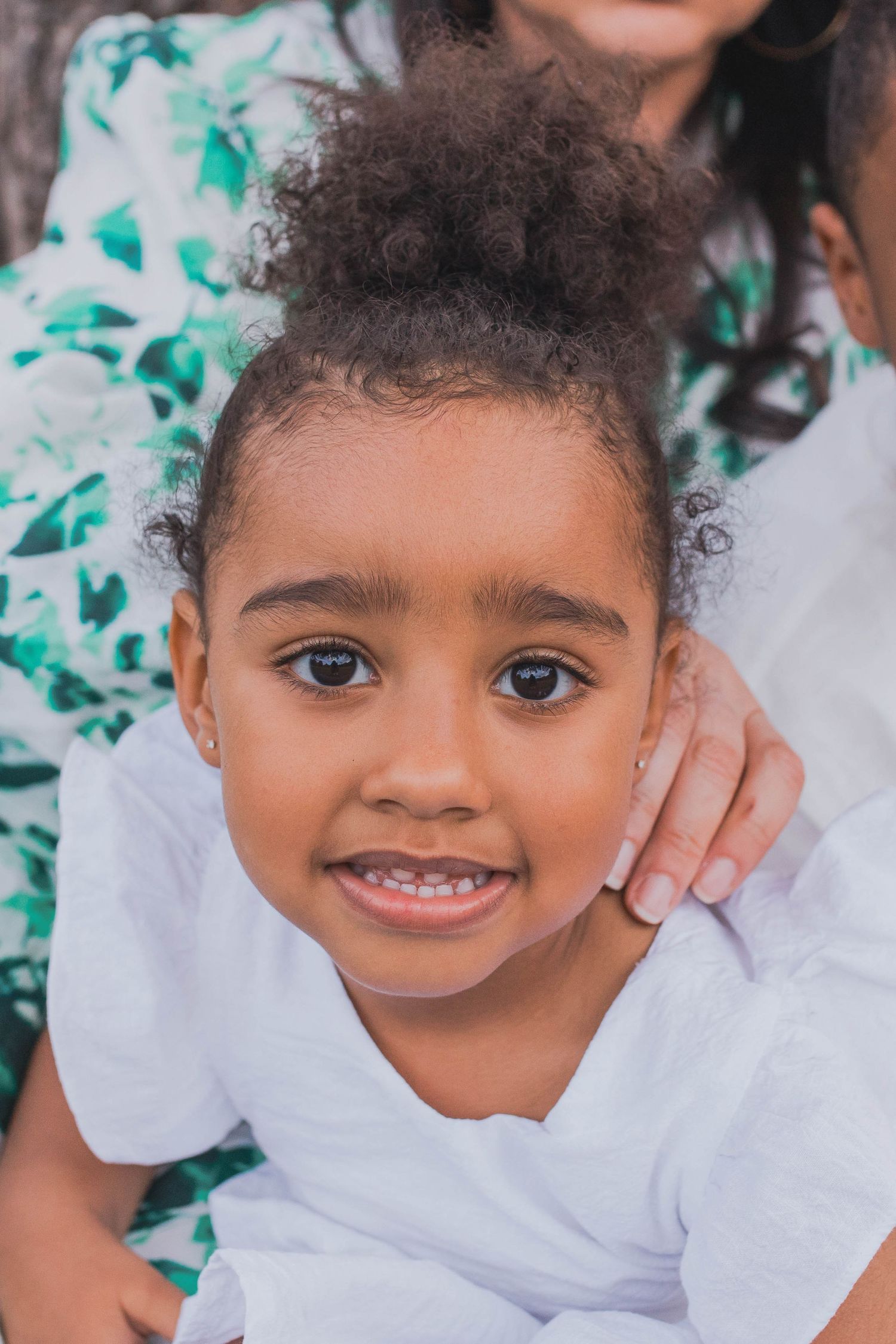 Close up of little girl looking at the camera mothers hand on her shoulder, Outdoor Family Session Newport Lakes Melb Vic