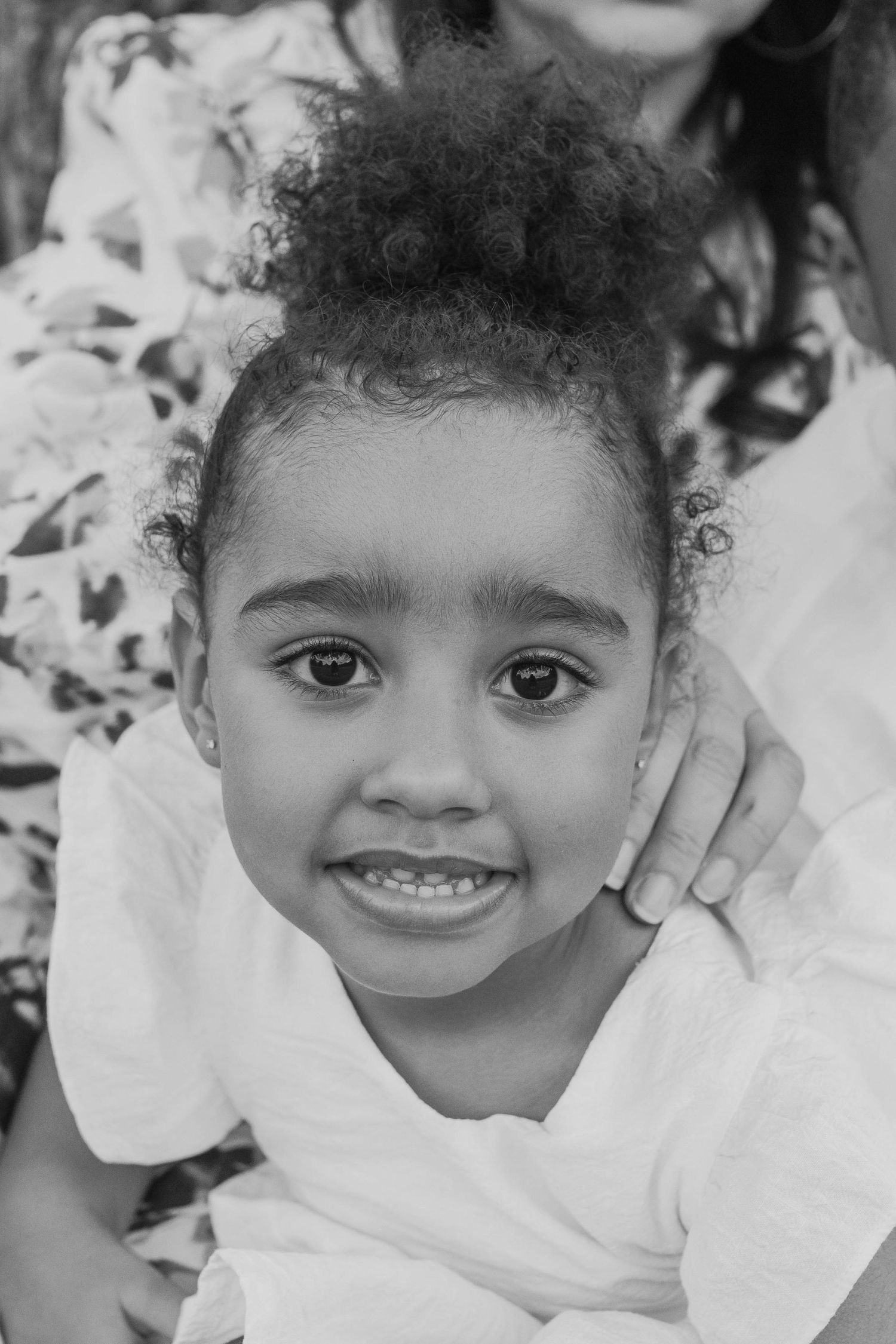Close up of little girl looking at the camera mothers hand on her shoulder, Outdoor Family Session Newport Lakes Melb Vic