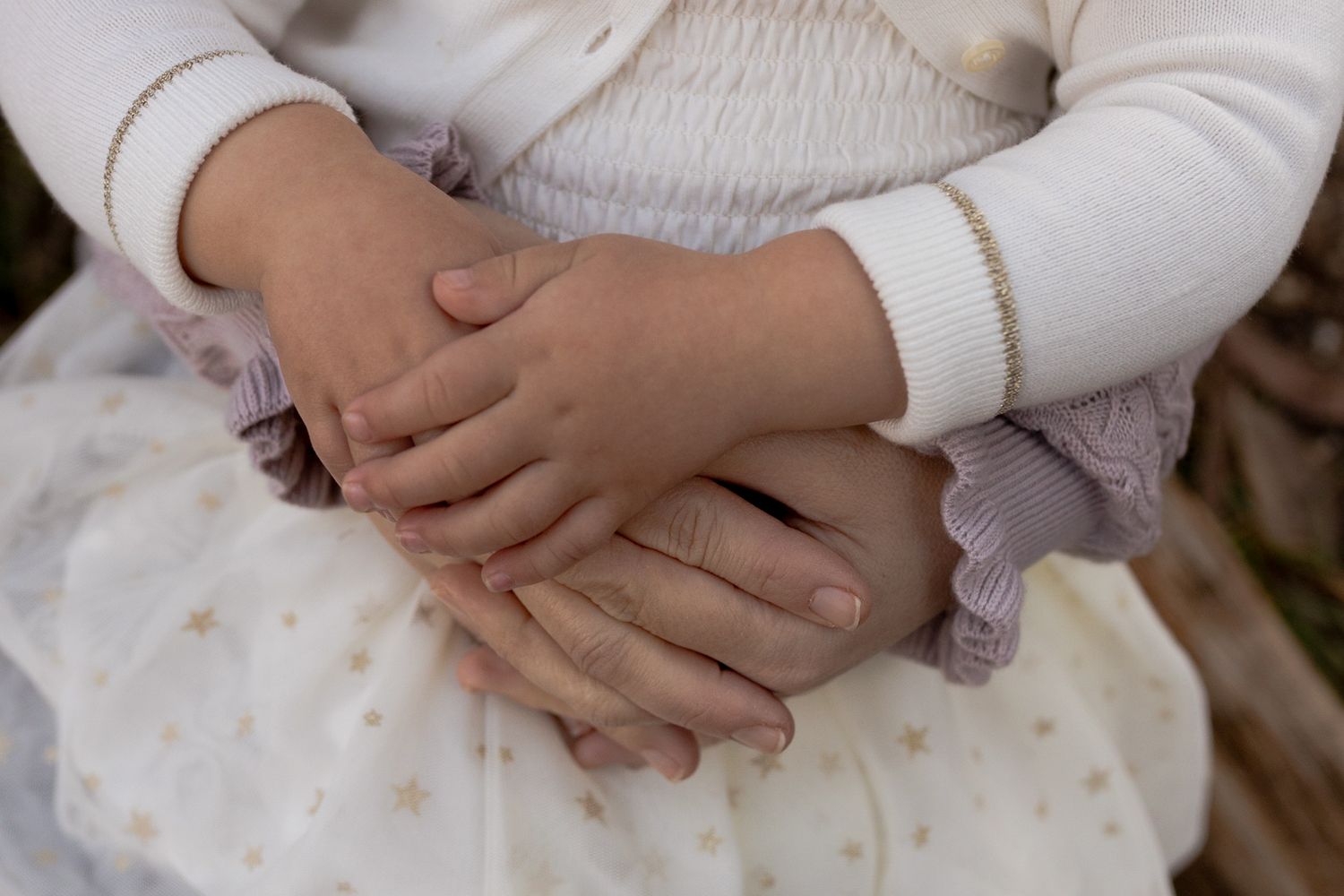 Close up of mum and daughters hands on top of each other Outdoor family session Macedon Ranges Melb Vic