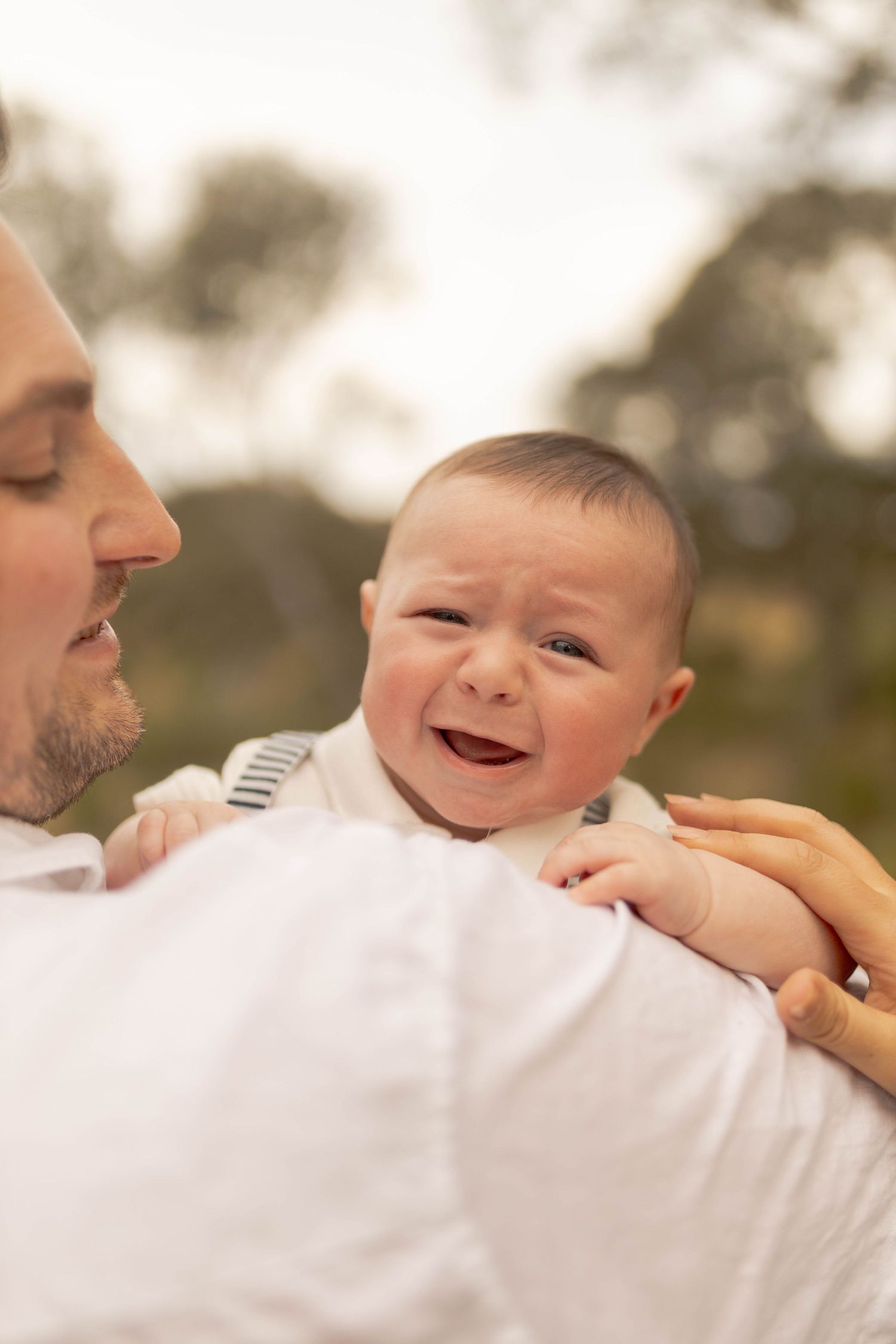 Newborn crying on the shoulder of his dad North Sunshine Newborn Photography Melbourne's West