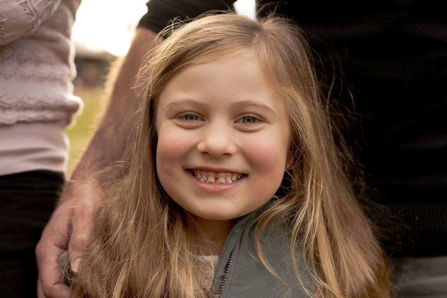Close up girl looking at the camera with a big smile outdoor family session Macedon Ranges Melb Vic