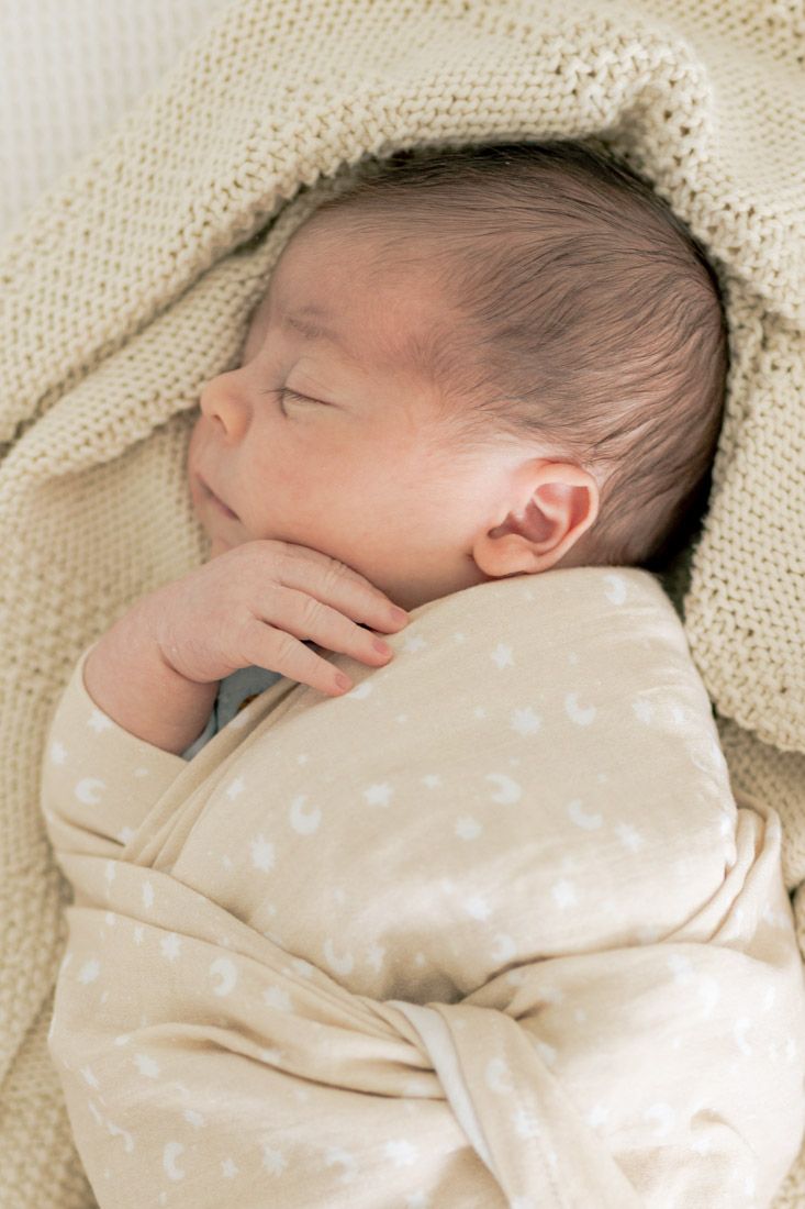 close up of Newborn baby boy wrapped in a soft blanket