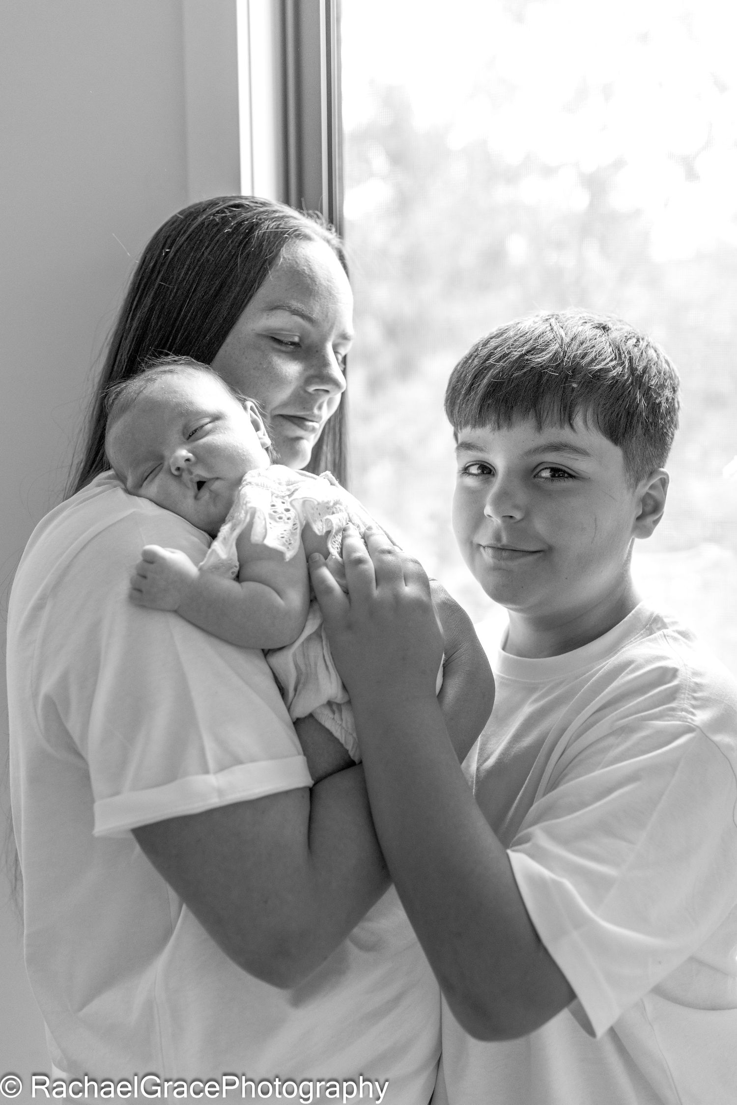Mum holding newborn and grown son hugging Newborn photoshoot North Sunshine