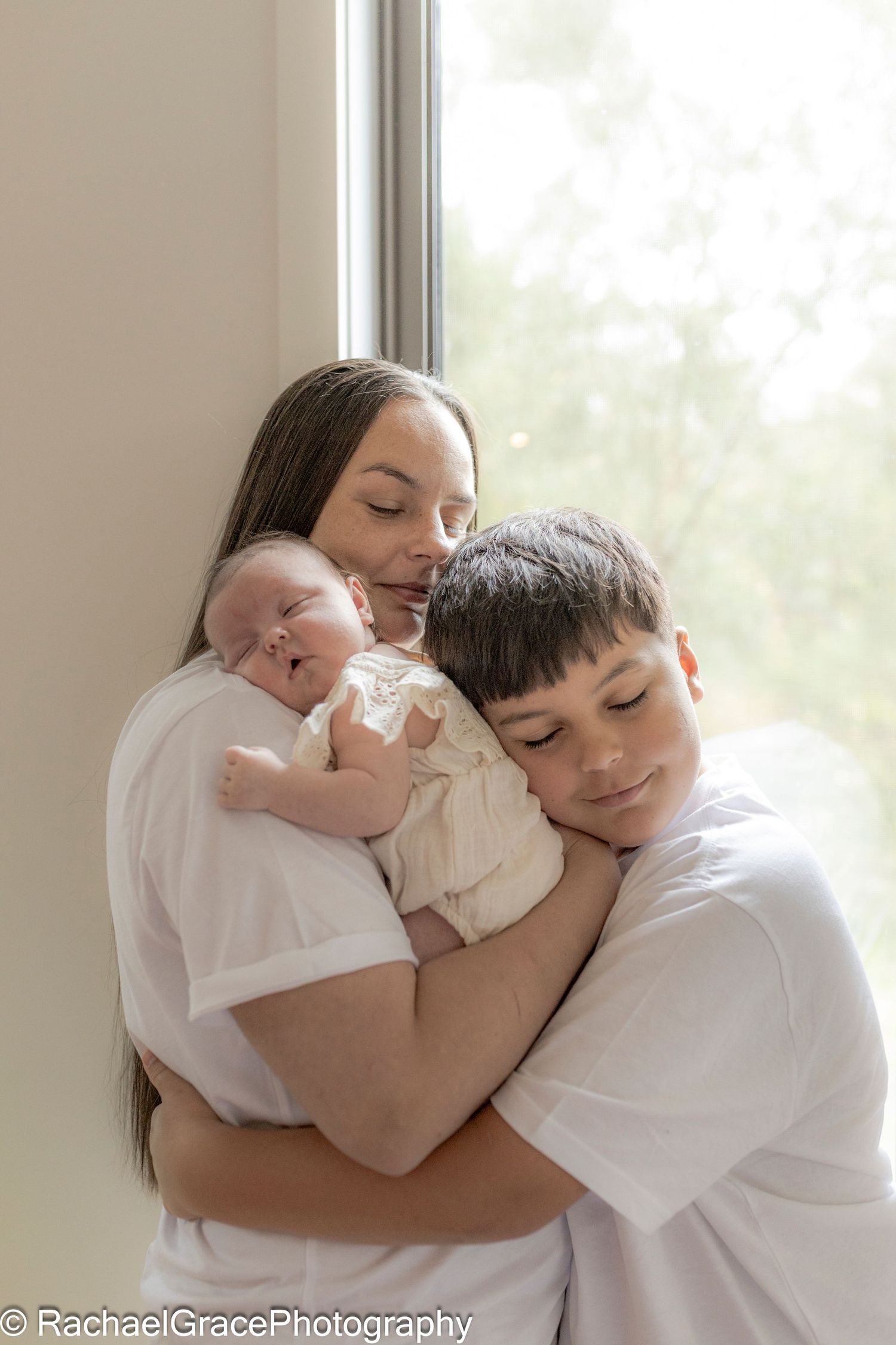 Mum holding newborn and grown son hugging Newborn photoshoot North Sunshine