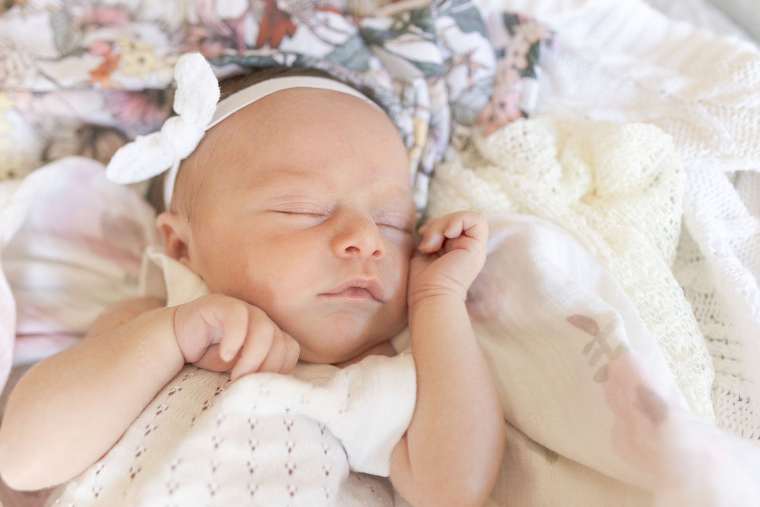 Newborn baby girl sleeping on the bed with floral swaddles at home newborn session, Caroline Springs Melb, Vic