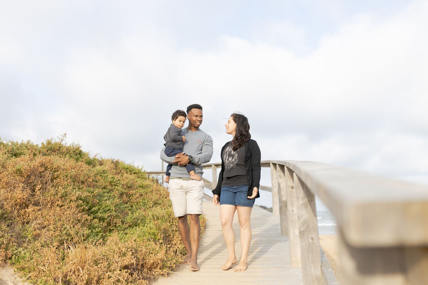 Family of three walking down the path near the beach Outdoor family session Torquay