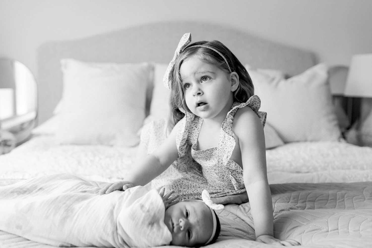 Sister holding on to newborn sister on the bed. at home newborn session Caroline Springs, Melbourne, Victoria