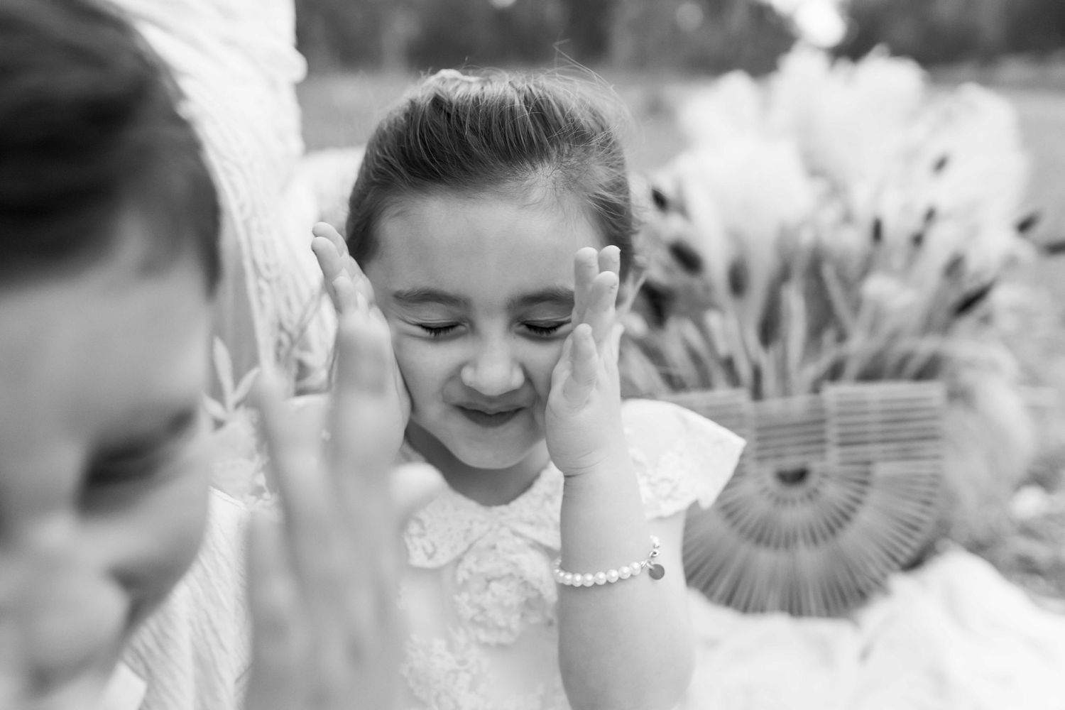 Little girl playing peek a boo black and white family outdoor photography Avondale Heights Melbourne's West Family photographer