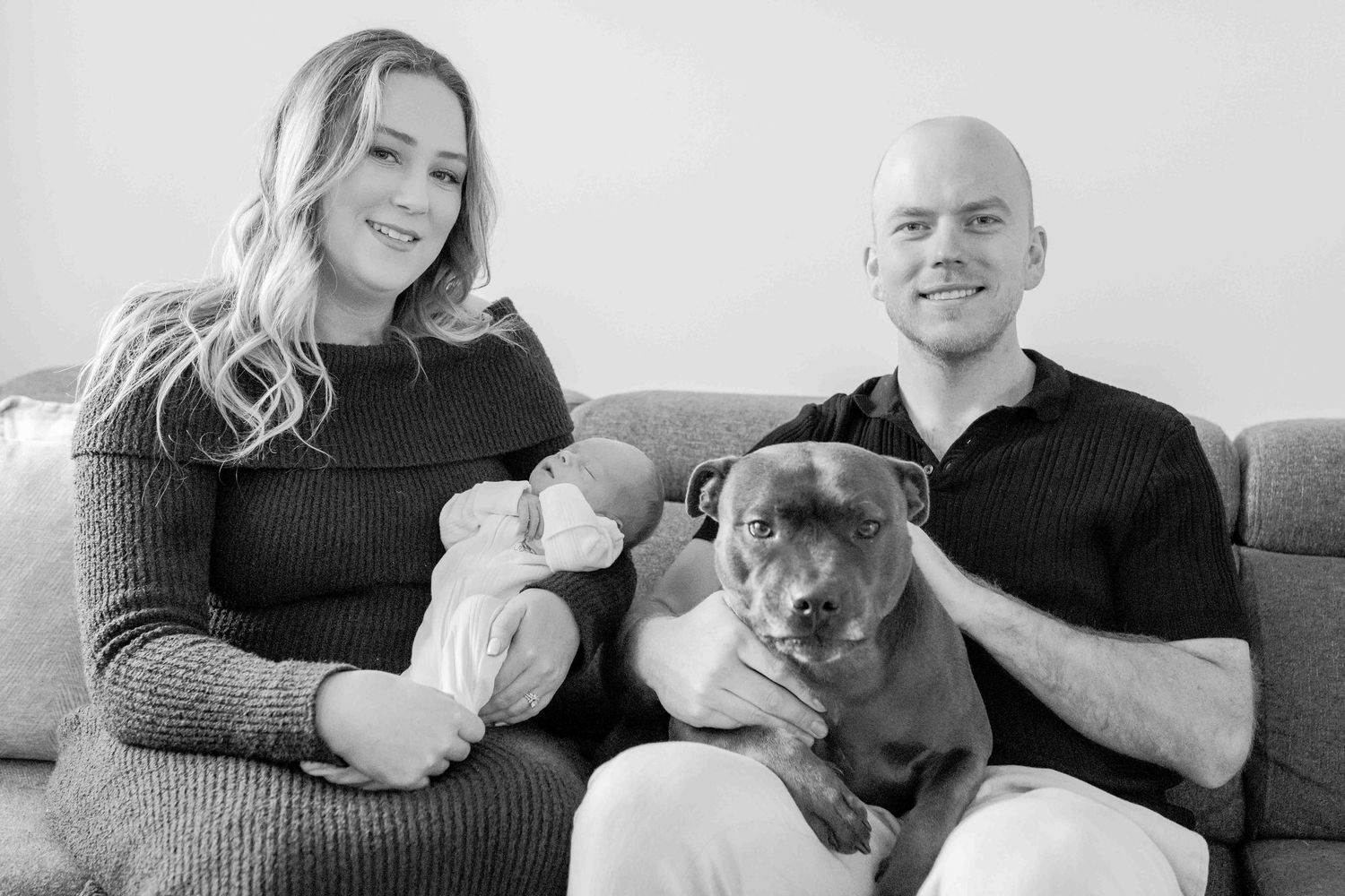 Parents newborn and dog sitting on the couch Melbourne Newborn Photography