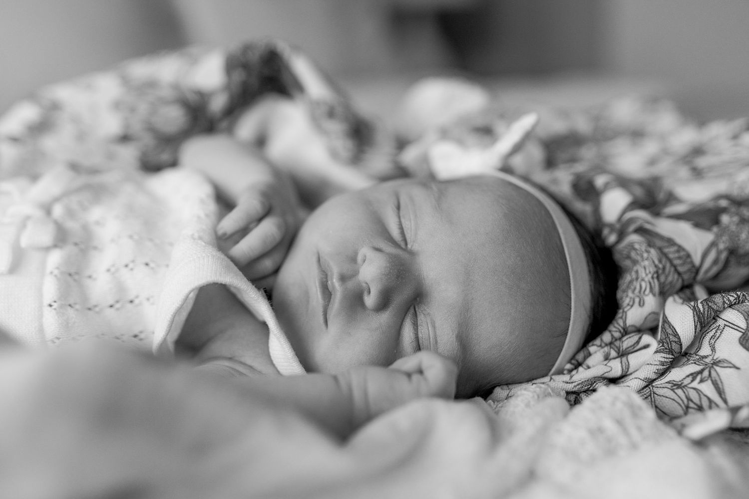 Newborn baby girl sleeping on the bed with floral swaddles at home newborn session, Caroline Springs Melb, Vic