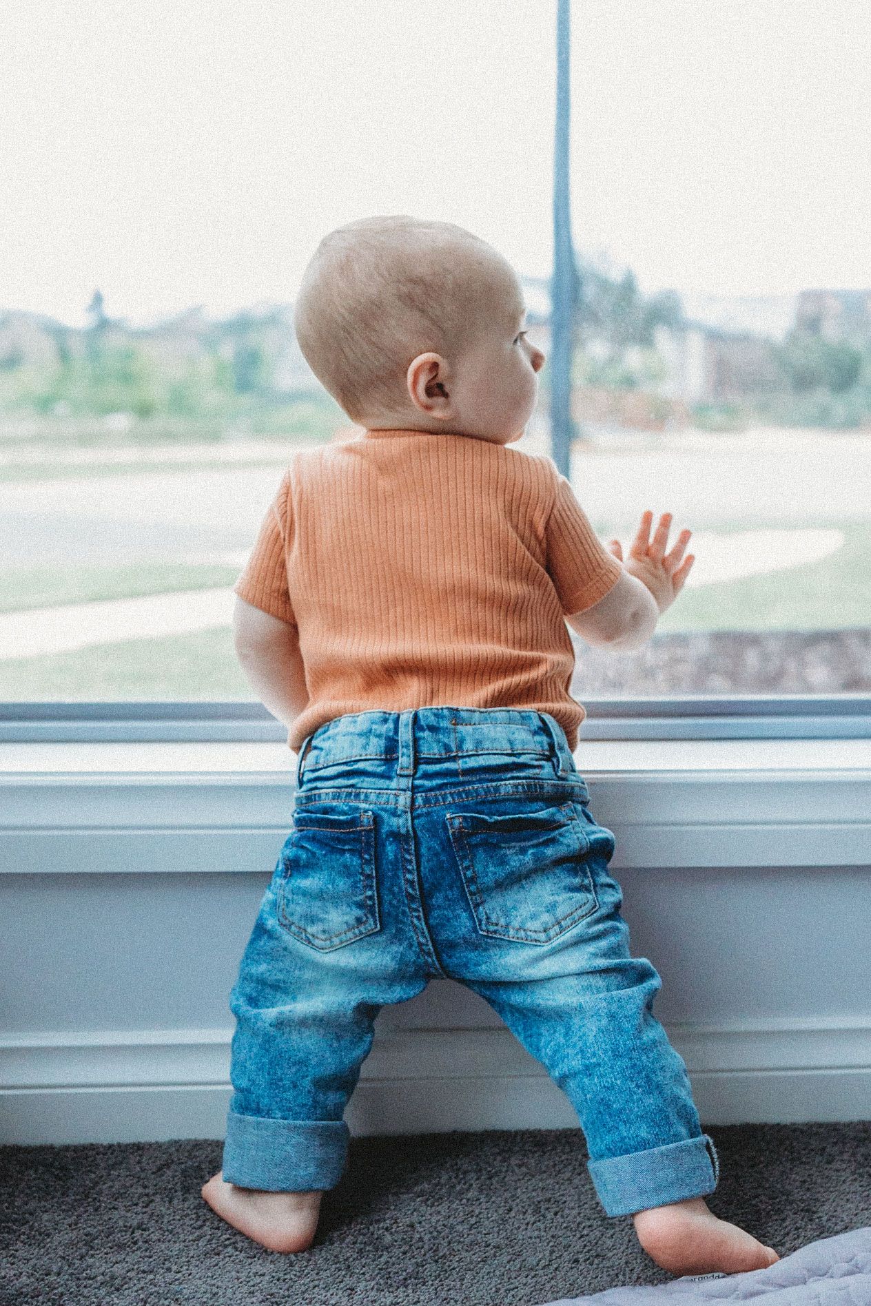 Toddler looking out of the window at home newborn session Taylors Hill, Melb, Vic