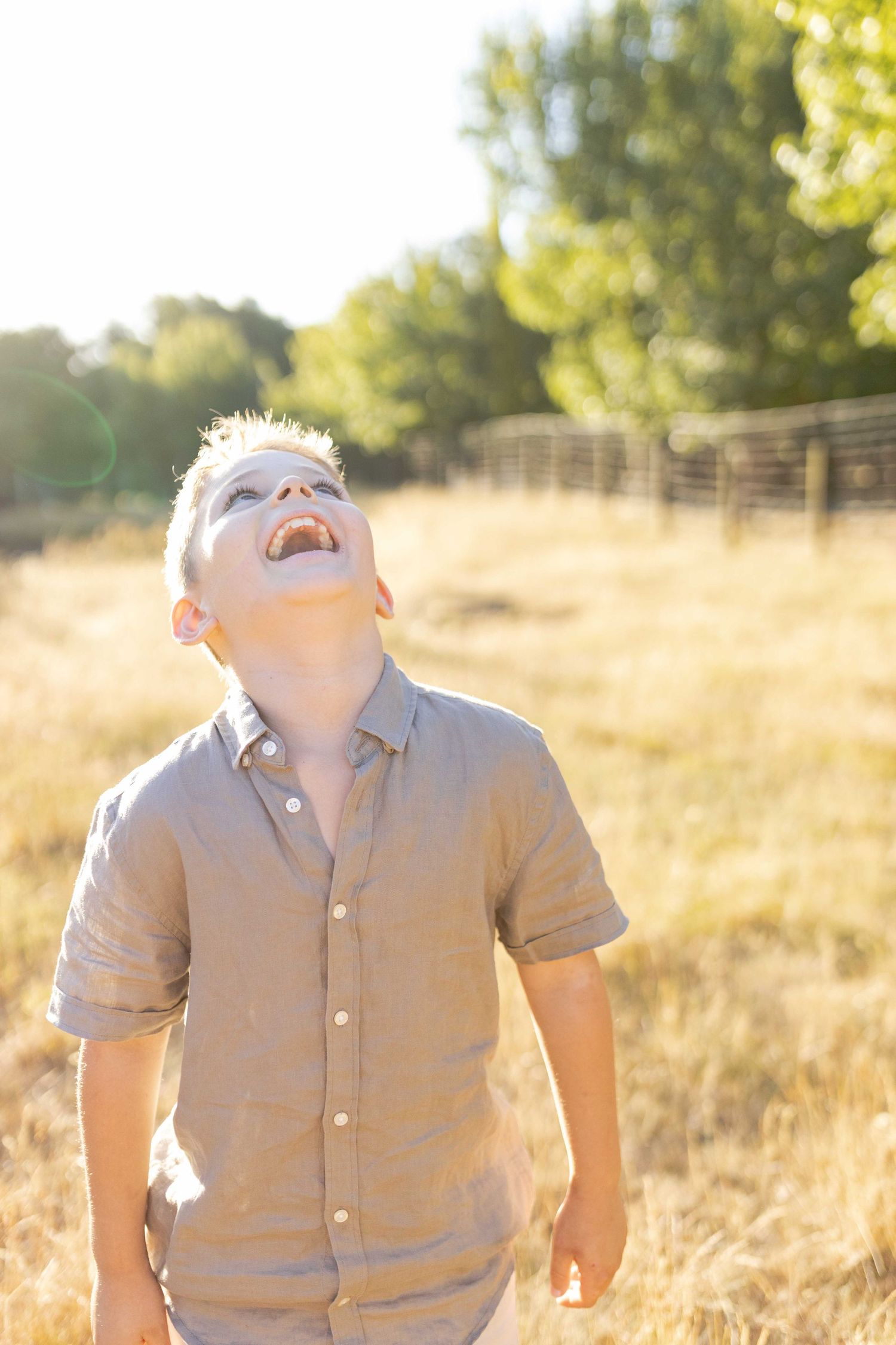 Boy having a big laugh Outdoor at home family session Gisborne Melb Vic