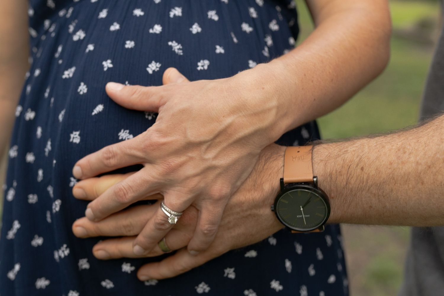 Maternity outdoor session close up of mum and dads hands are holding on to mum's belly, Coburg Melb, Vic