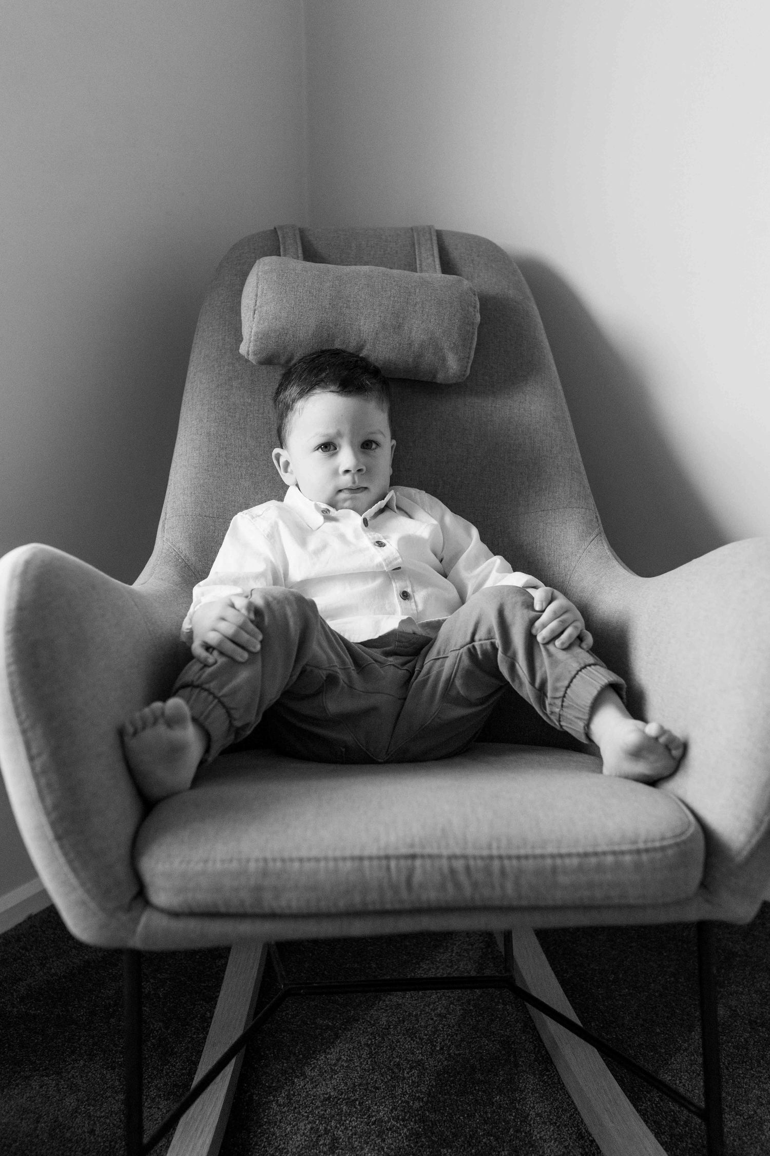 Toddler sitting in a big chair at home newborn session  Tullamarine Melb Vic