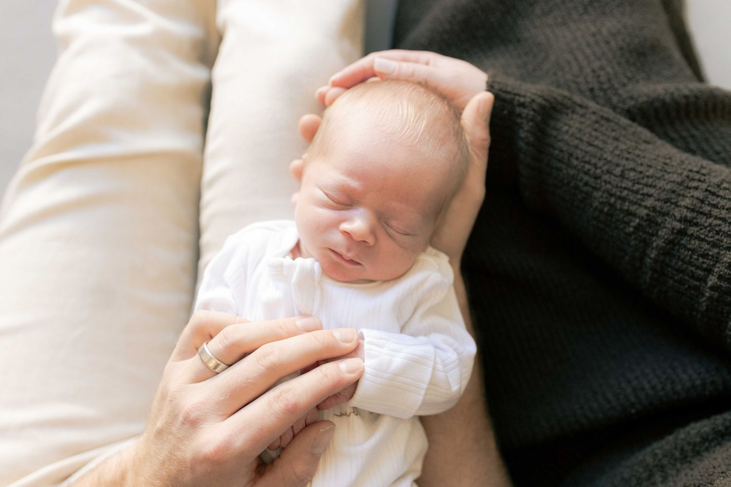 Looking down from on top of the parents head looking down at the newborn boy lying in their laps Newborn photography Melbourne's West Melton