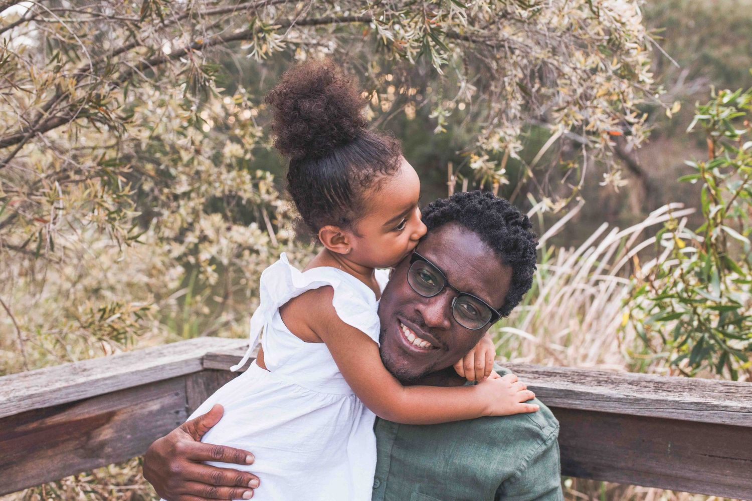 Daughter kissing dad on the head outdoor family session   Newport Lakes Melb Vic