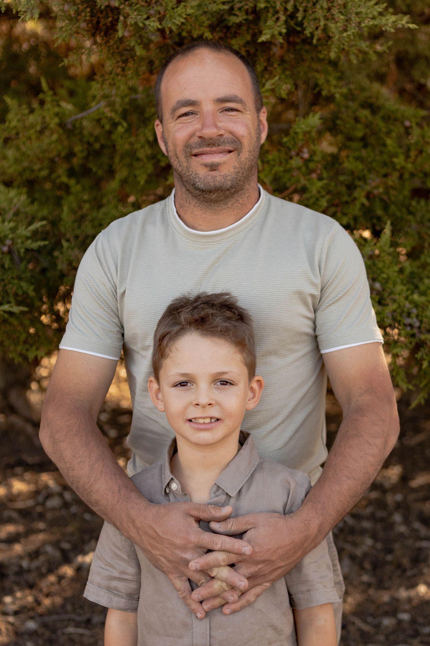 Father with his arms around his son smiling Outdoor at home family session Gisborne Melb Vic
