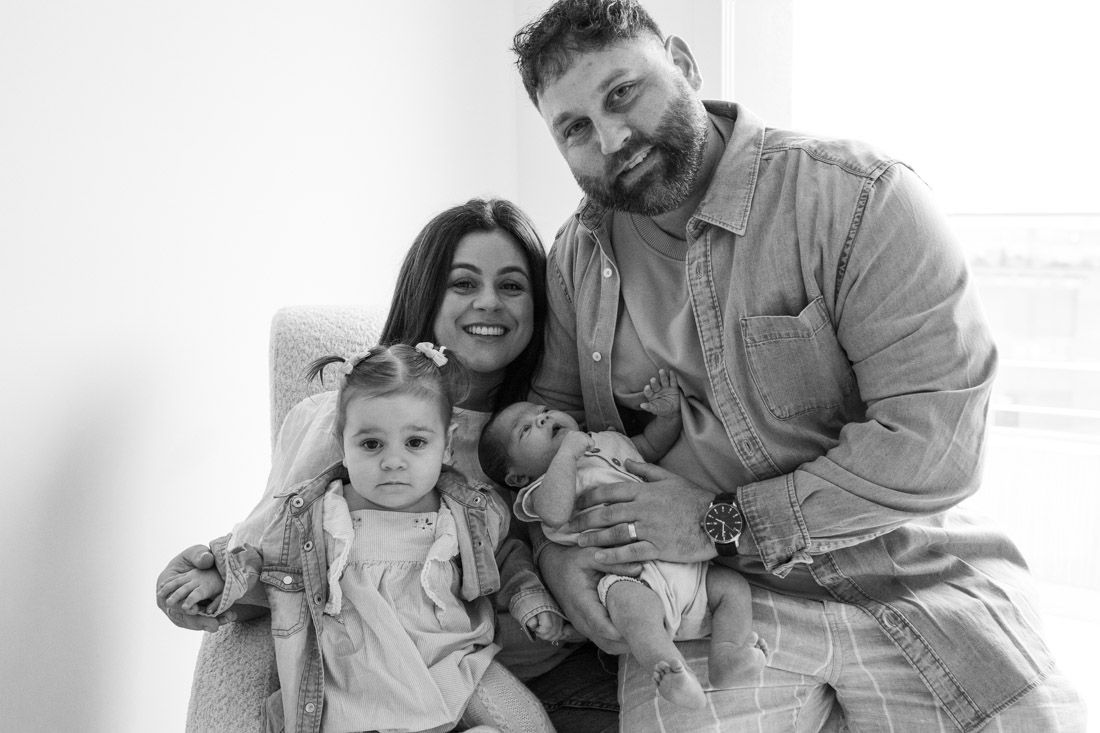 Family smiling and hugging newborn photoshoot Melbourne's West