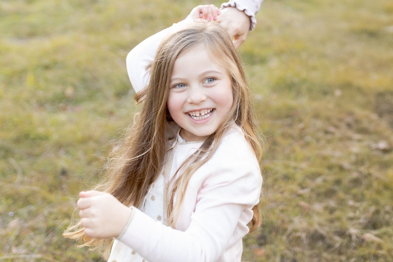 Girl twirling in a field big smileOutdoor family session Macedon Ranges Melb Vic