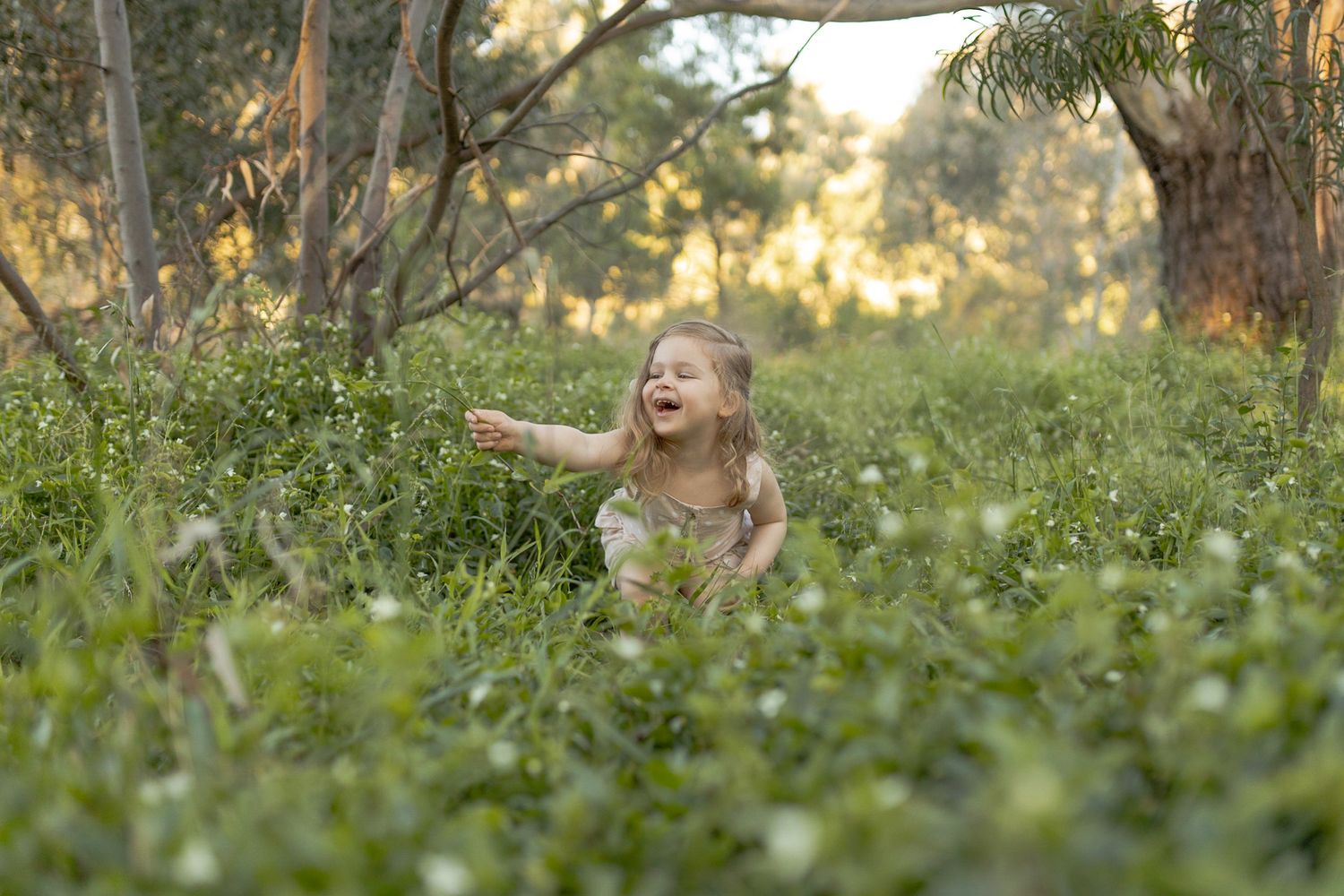 Little girls in a field of wild flowers laughing outdoor family session Sunshine North, Melb, Vic