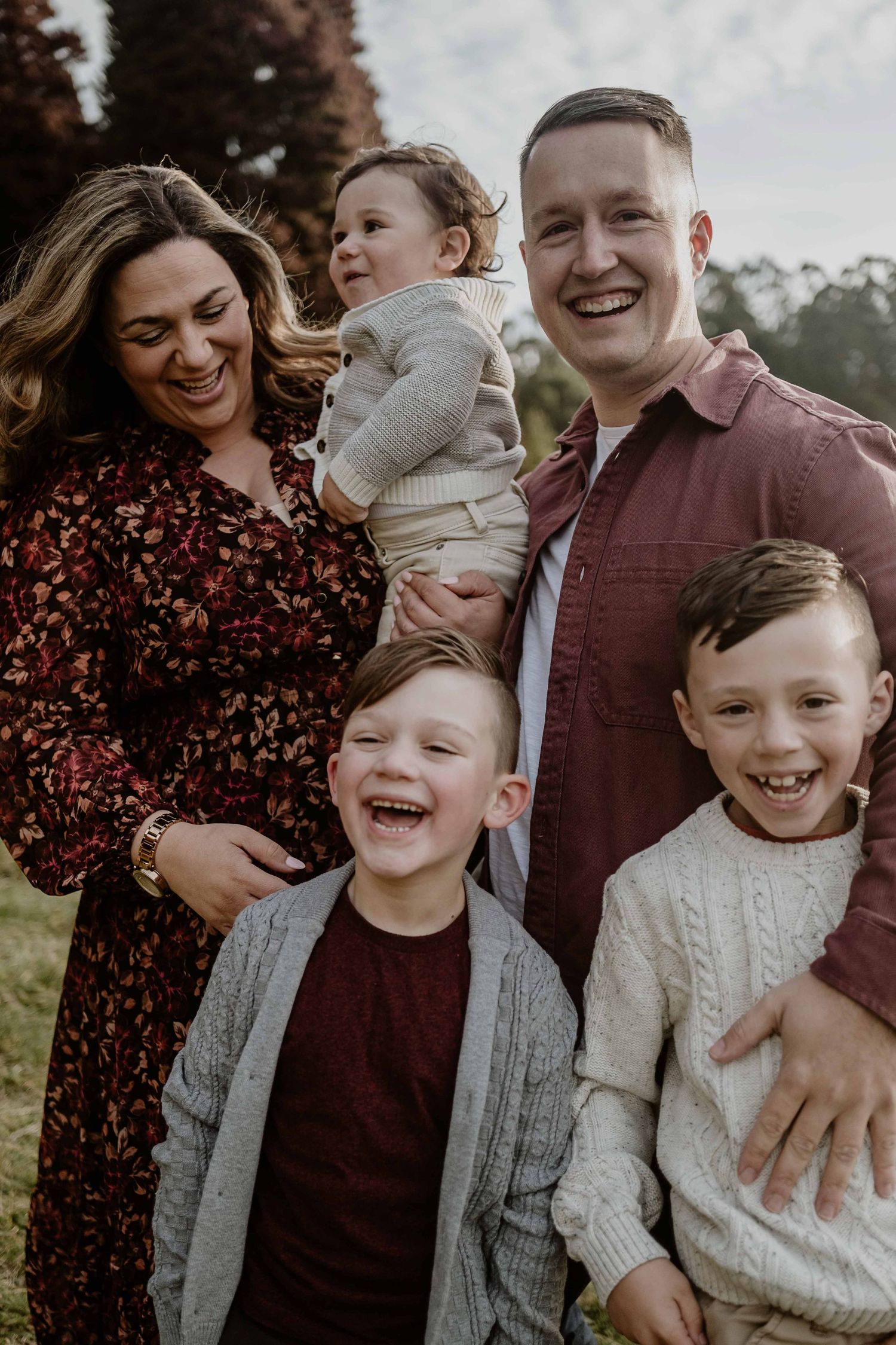 Family of five cuddling laughing and smiling lots of connection happy family