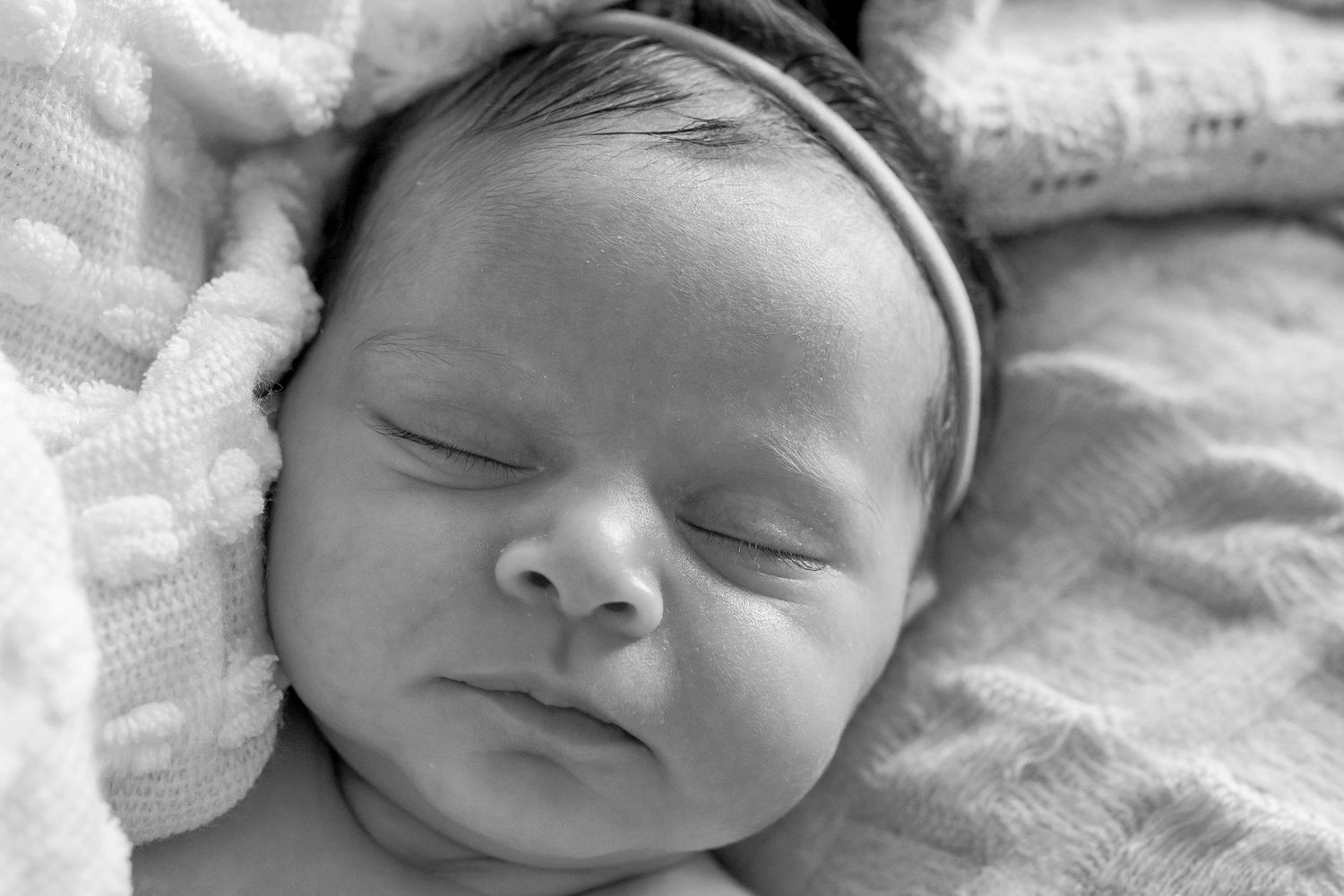 Close up of sleeping baby girl with soft blankets around her. At hone newborn session Point Cook, Melb, Vic