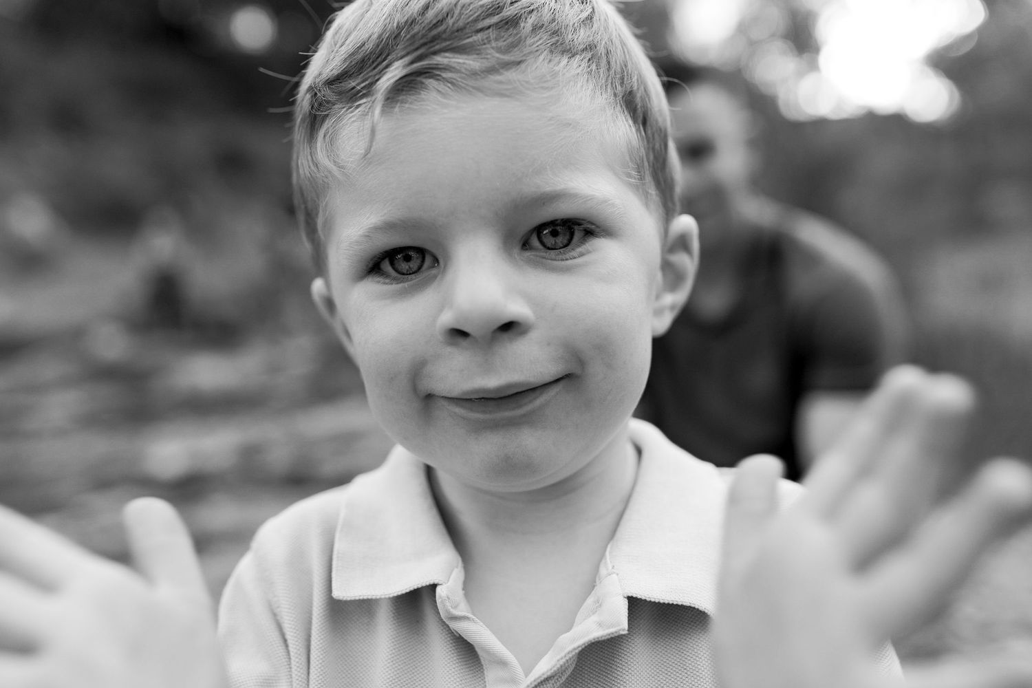 Toddler smiling with his hands out playing peek a boo Coburg lake Melb Vic outdoor maternity session