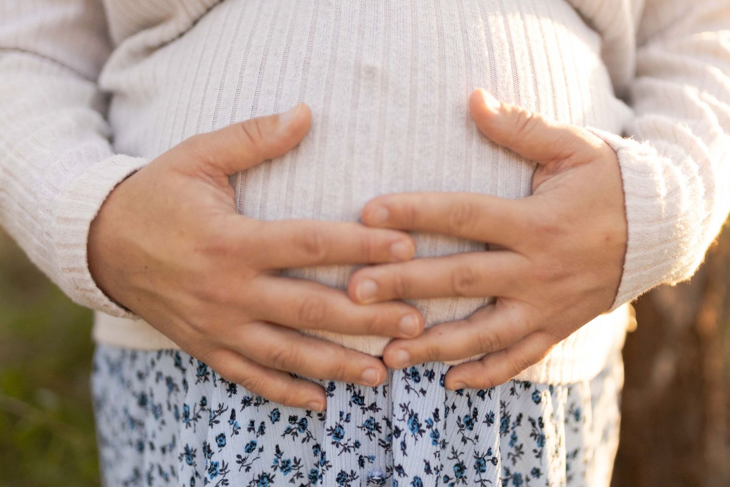 Mum holding onto her belly Outdoor maternity session Sunshine Melb Victoria
