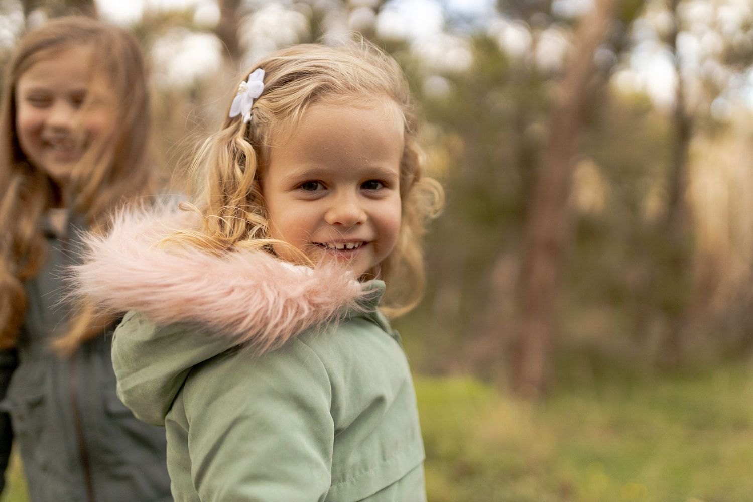 Little girl looking at the camera with a smile outdoor family session Macedon Ranges Melb Vic