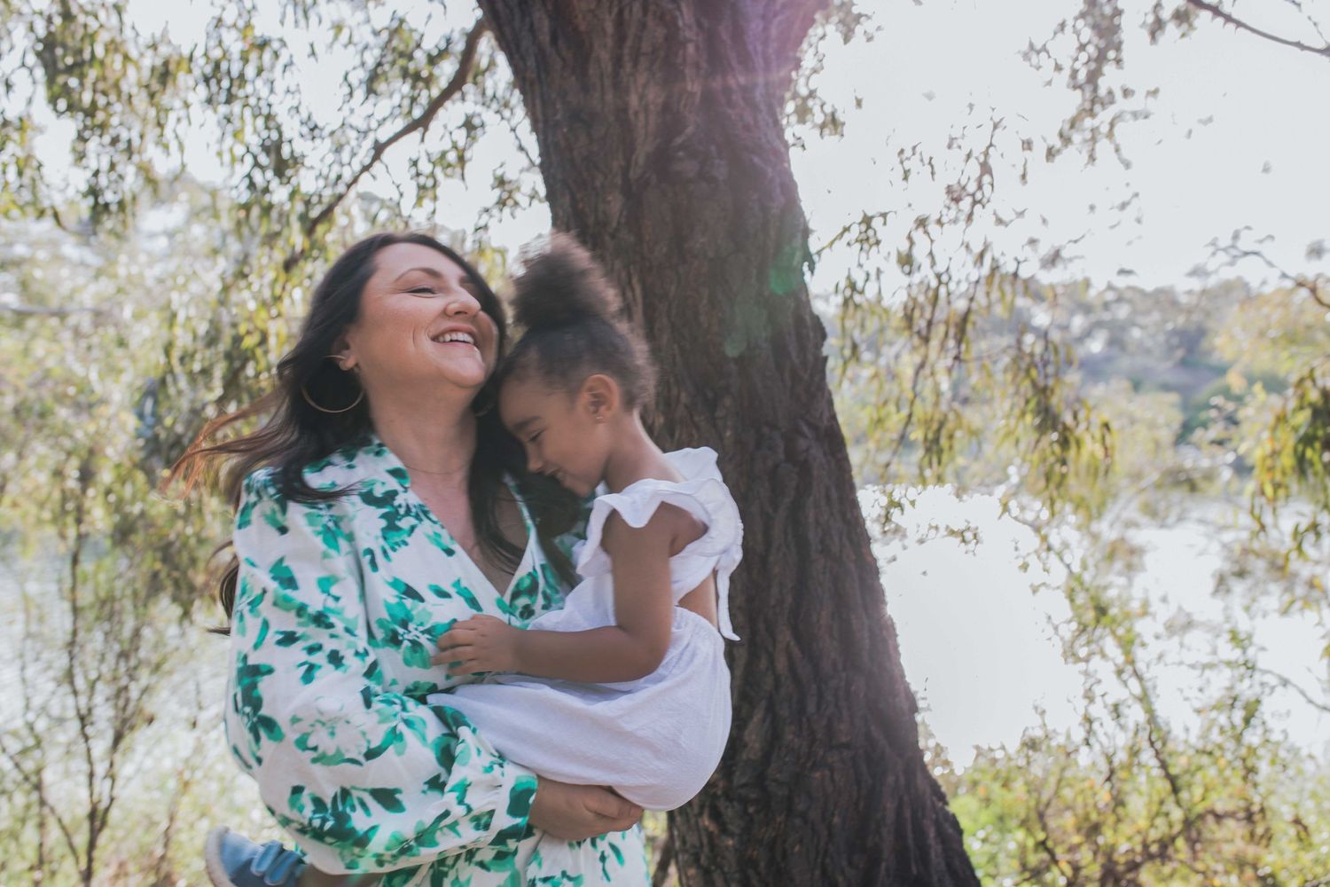 Mother holding daughter smiling warm sunlight outdoor family session Newport Lakes, Melb, Vic