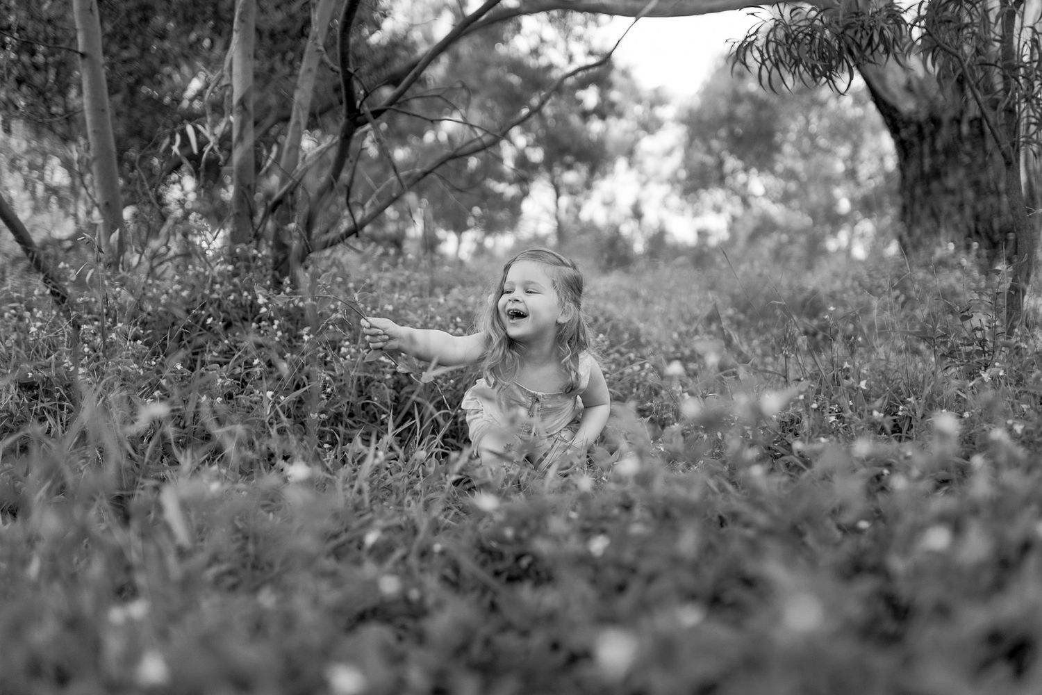 Little girls in a field of wild flowers laughing outdoor family session Sunshine North, Melb, Vic