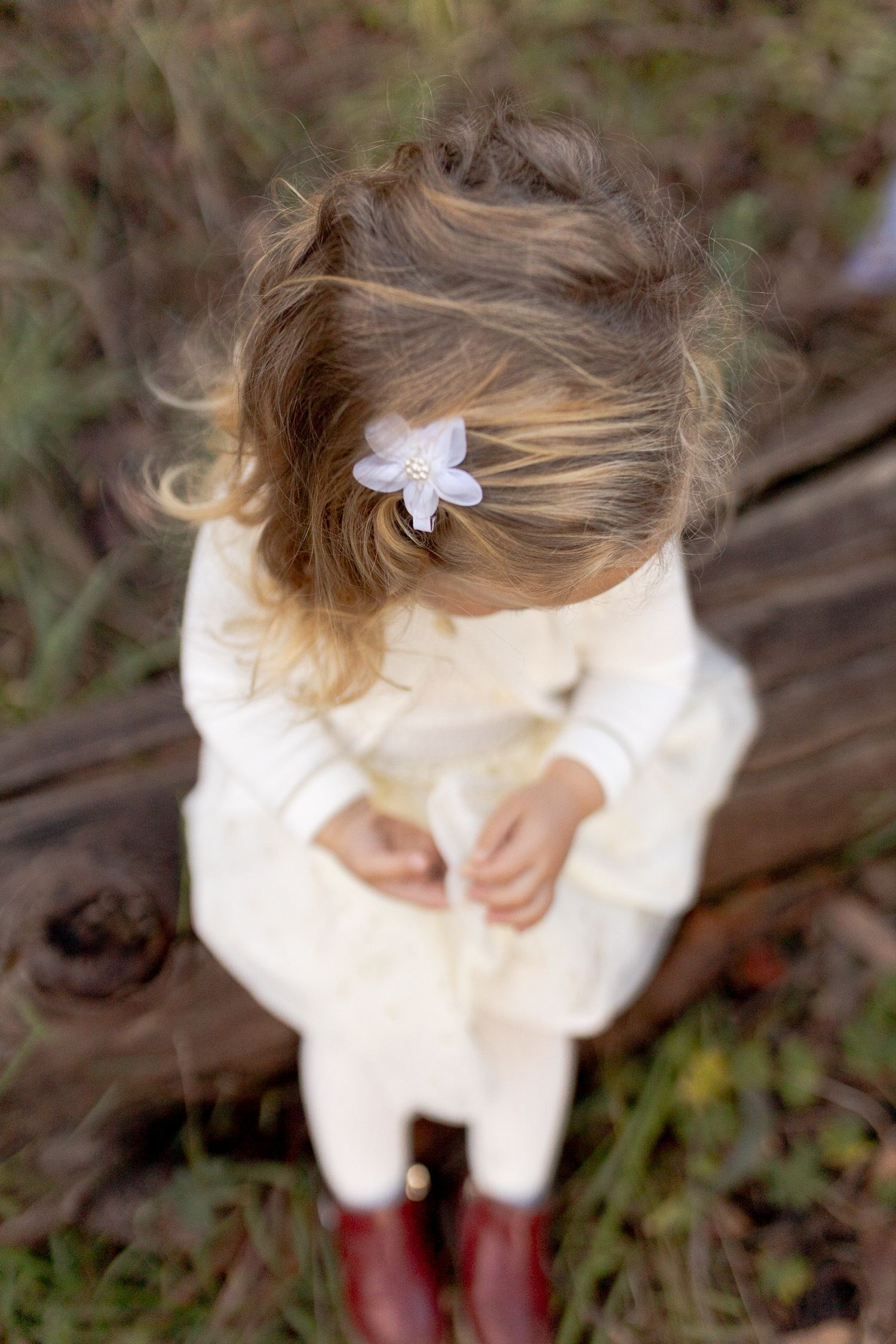 Looking down on a little girls blonde ringlets whimsical and fairytale like outdoor family session Macedon Ranges Melb Vic