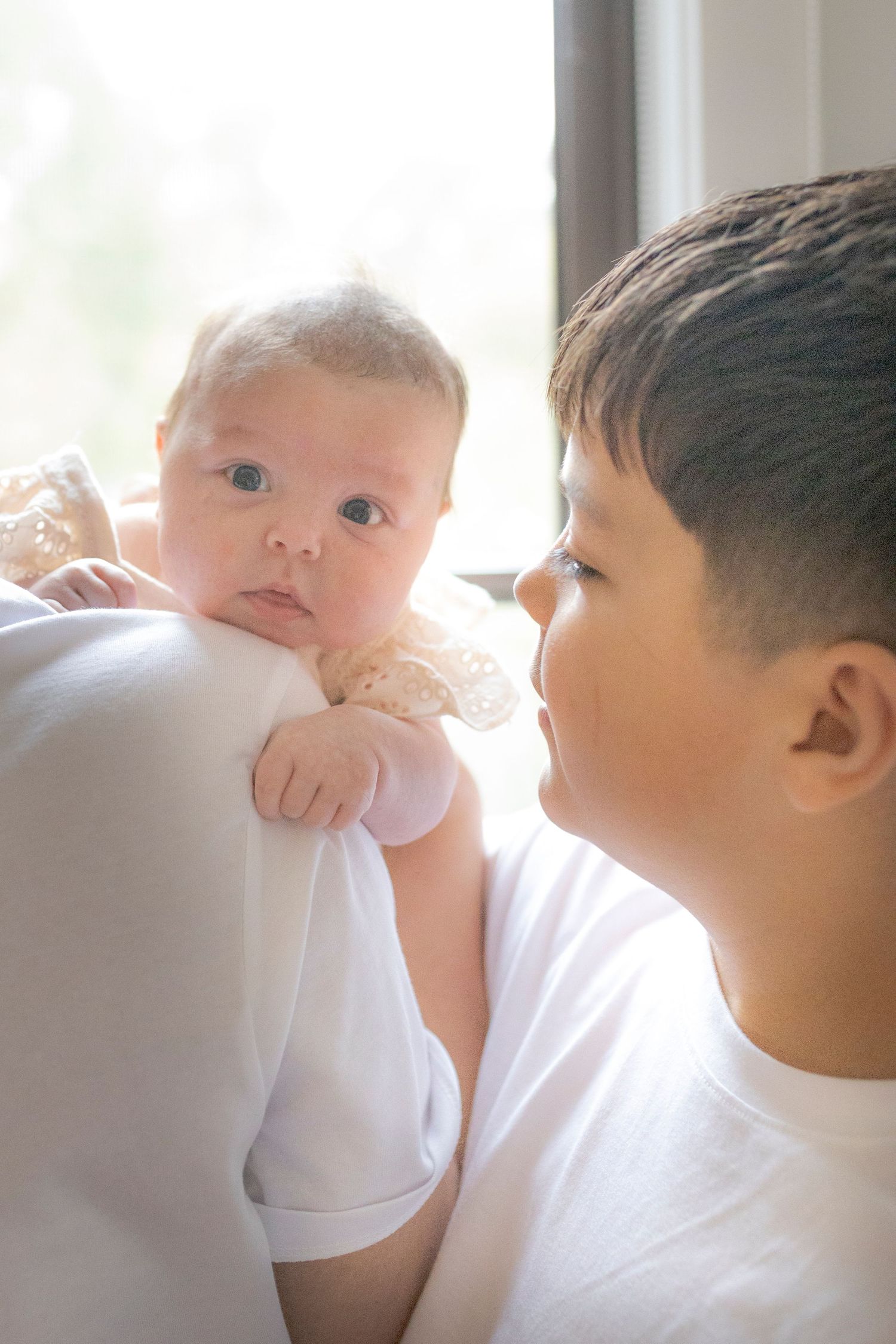 Big brother looking at his newborn sister newborn photoshoot Melbourne west