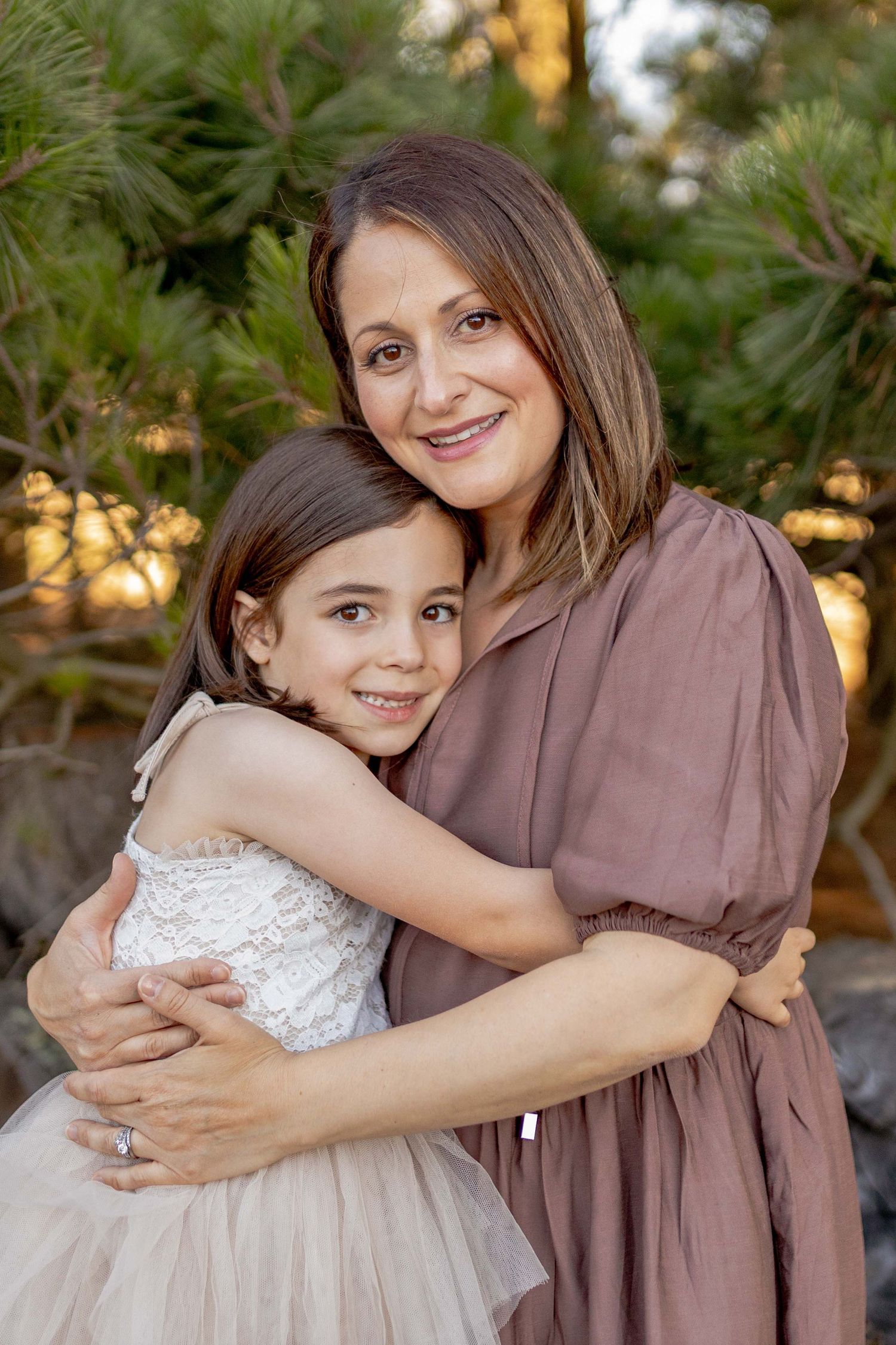 Mother and daughter hugging and smiling Outdoor at home family session Gisborne Melb Vic
