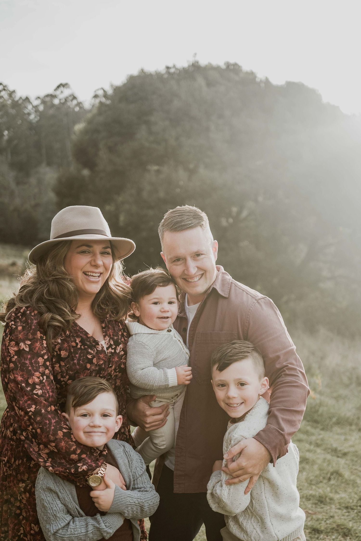 Candid family of five cuddling lots of smiles three boys boy fam