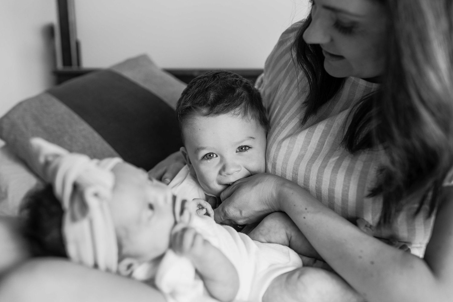 Mum hugging newborn daughter and toddler son, laughing and cuddling on the bed. At home newborn session, Tullamarine Melb, Vic