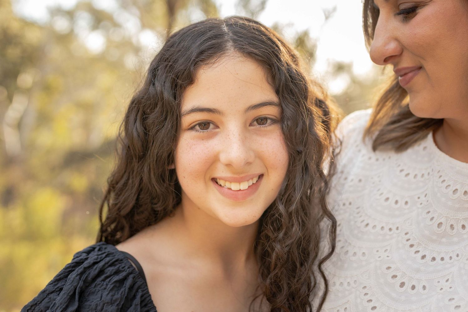 Close up pre teen smiling and looking into the camera warm sunlight outdoor family session Newport Lakes, Melb, Vic