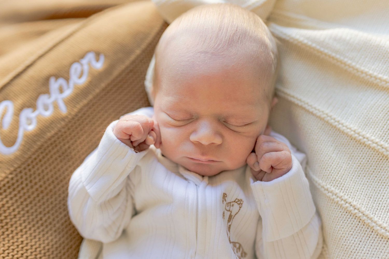 Newborn close up lying on top off the warm blankets