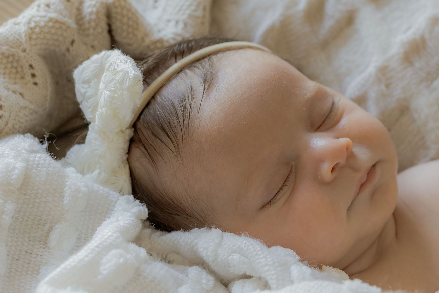 Close up of sleeping baby girl with soft blankets around her. At hone newborn session Point Cook, Melb, Vic