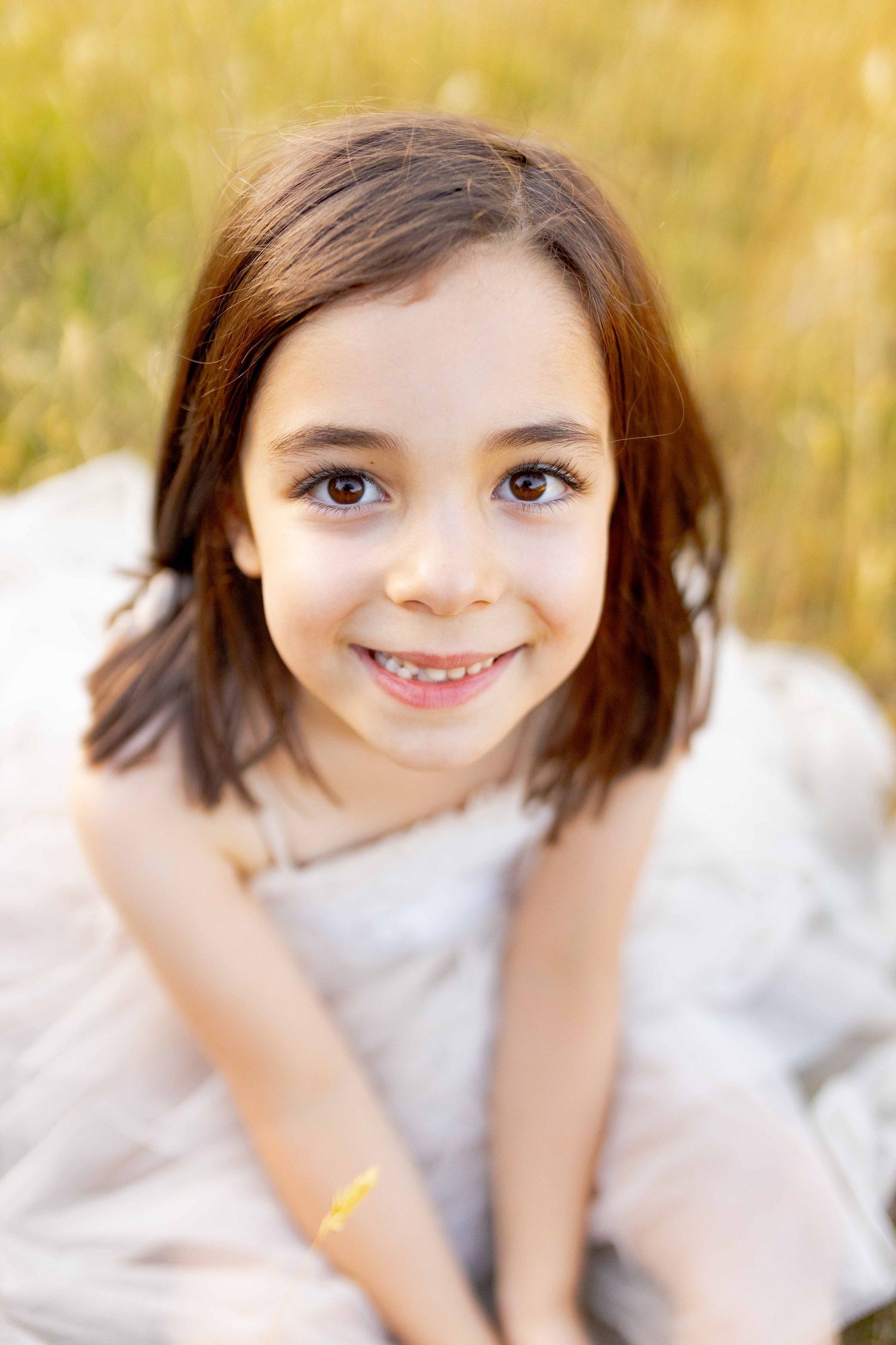 Little girl looking up and smiling  Outdoor at home family session Gisborne Melb Vic