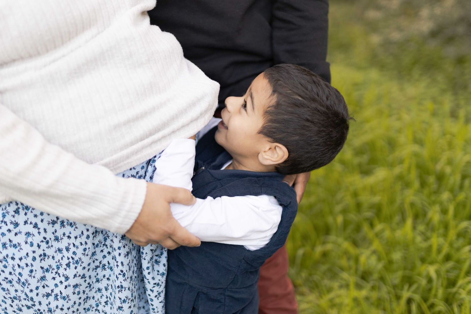 Toddler hugging his mothers tummy maternity outdoor session Sunshine North Melb Vic