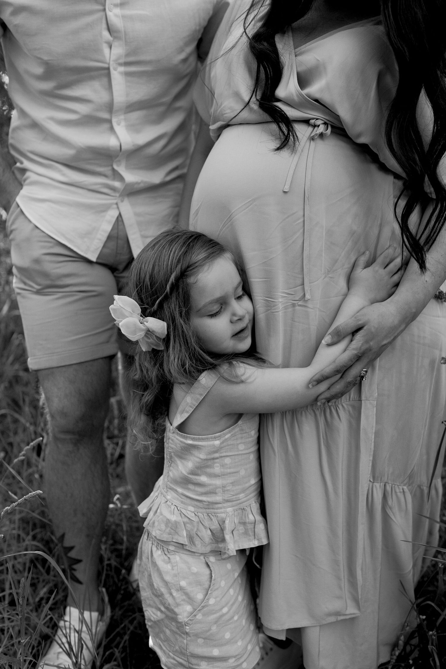 Daughter hugging mums belly outdoor maternity session Sunshine North, Melb, Vic